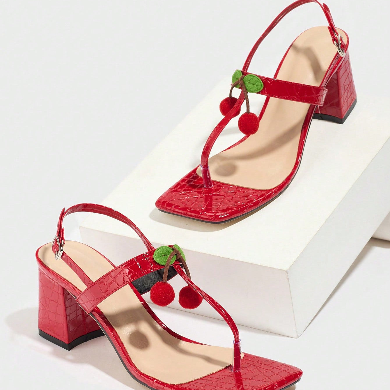 Mescini - Red square toe block heel sandal pair on a white riser, studio view, US sizes