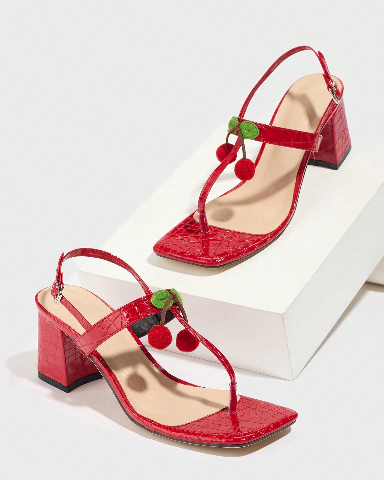 Mescini - Red square toe block heel sandal pair on a white riser, studio view, US sizes