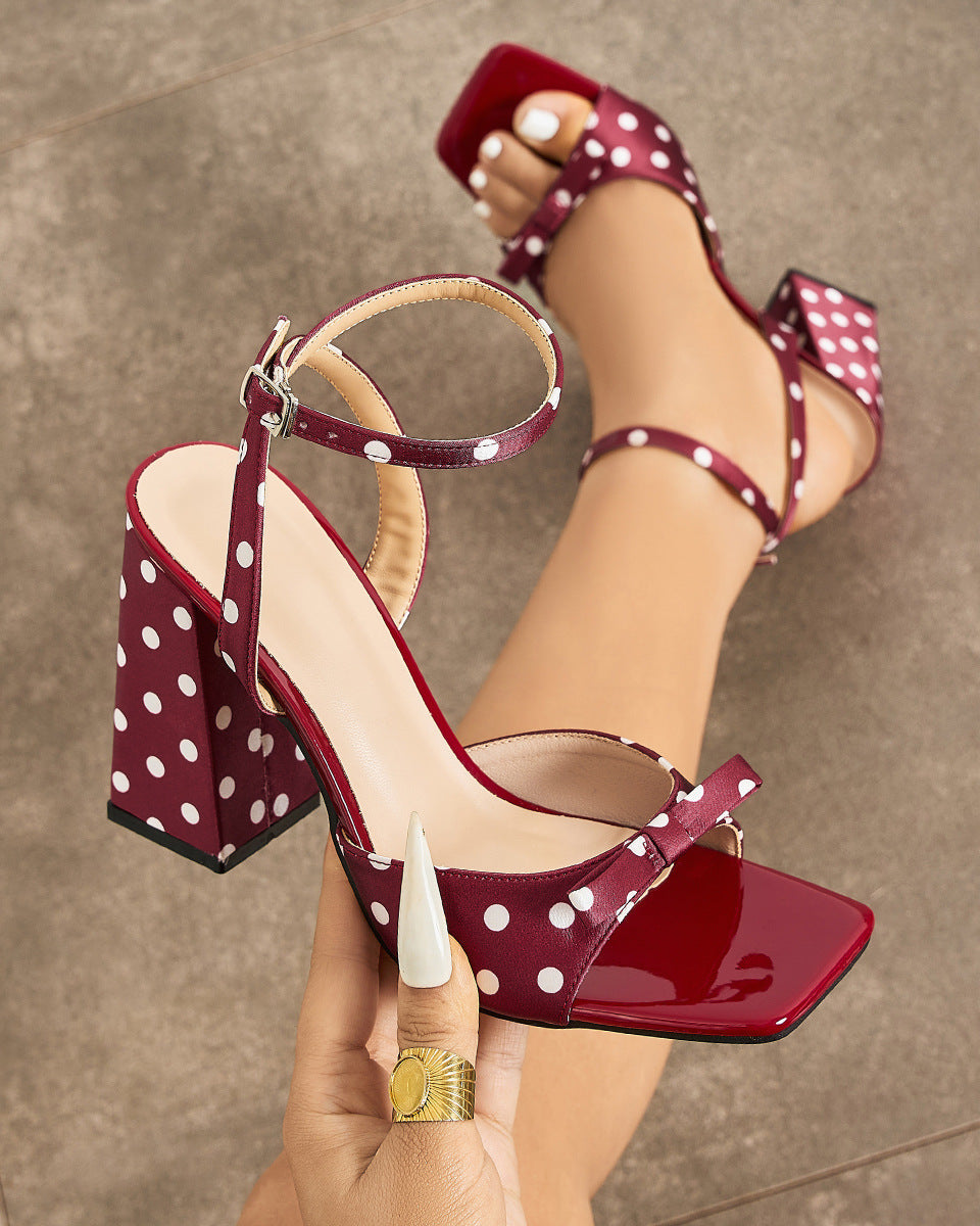 Mescini - Burgundy polka dot block heel sandal held in hand, square toe cap view, US sizes