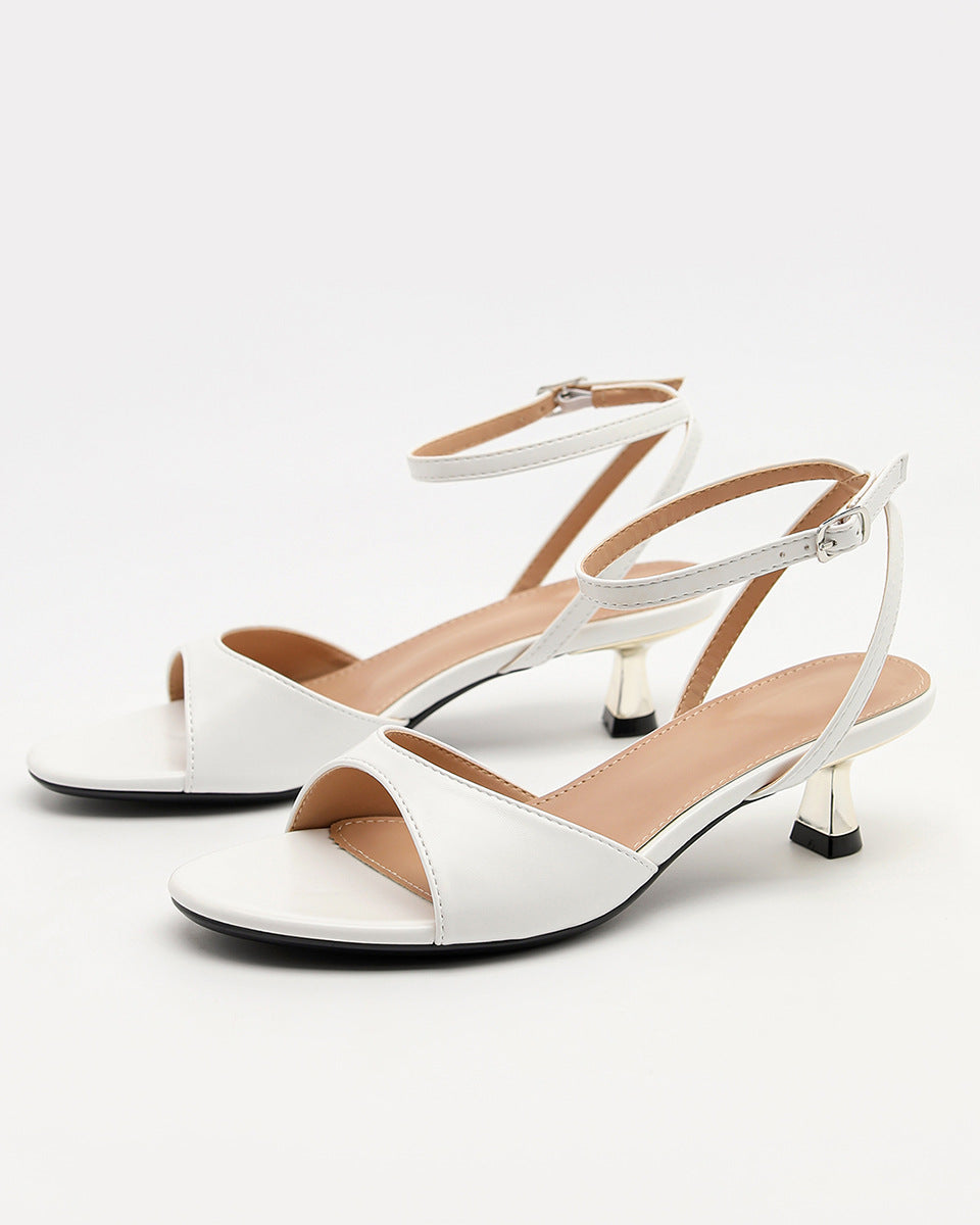 Mescini - White ankle strap sandals pair photographed at a three quarter angle, US women's sizes