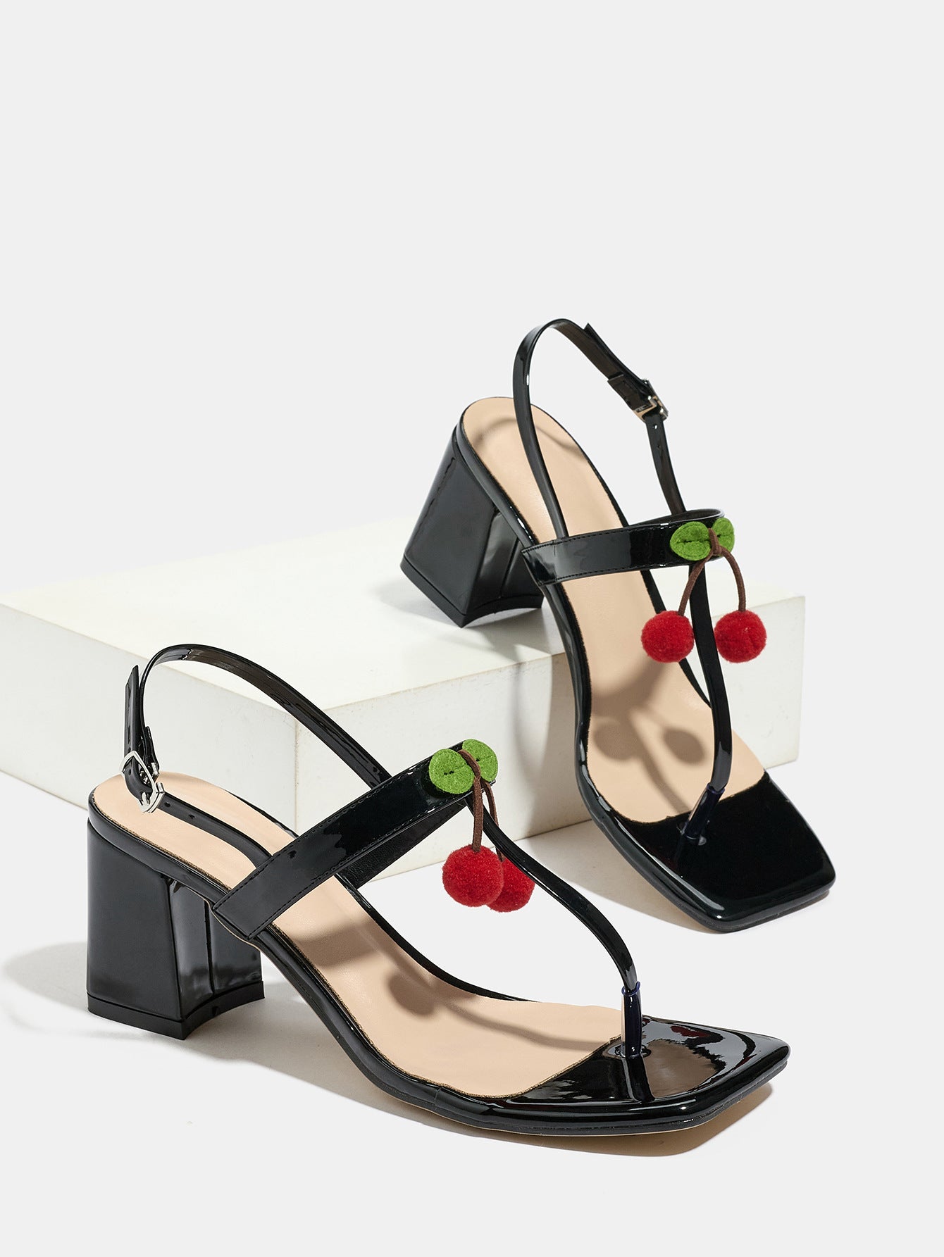 Mescini - Black square toe block heel sandal pair beside a white block, studio view, US
