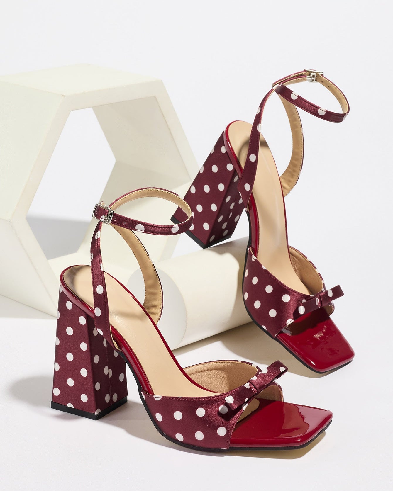 Mescini - Burgundy polka dot block heel sandal pair on a white riser, studio view, US