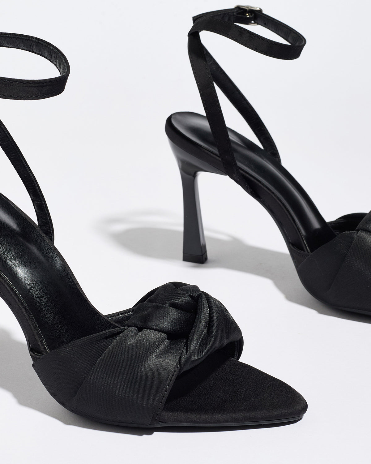 Mescini black knotted satin ankle strap sandals, close up of one shoe at an angle, US women's sizes