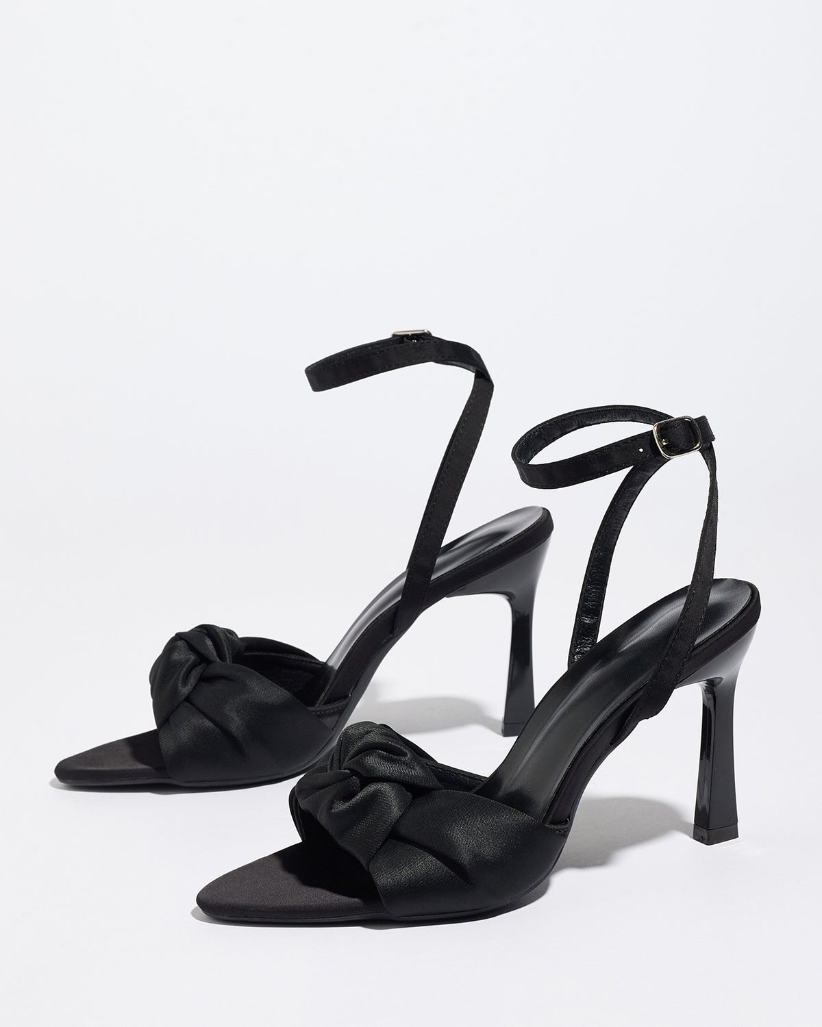 Mescini black knotted satin ankle strap sandals, pair angled on a plain surface, US women's sizes