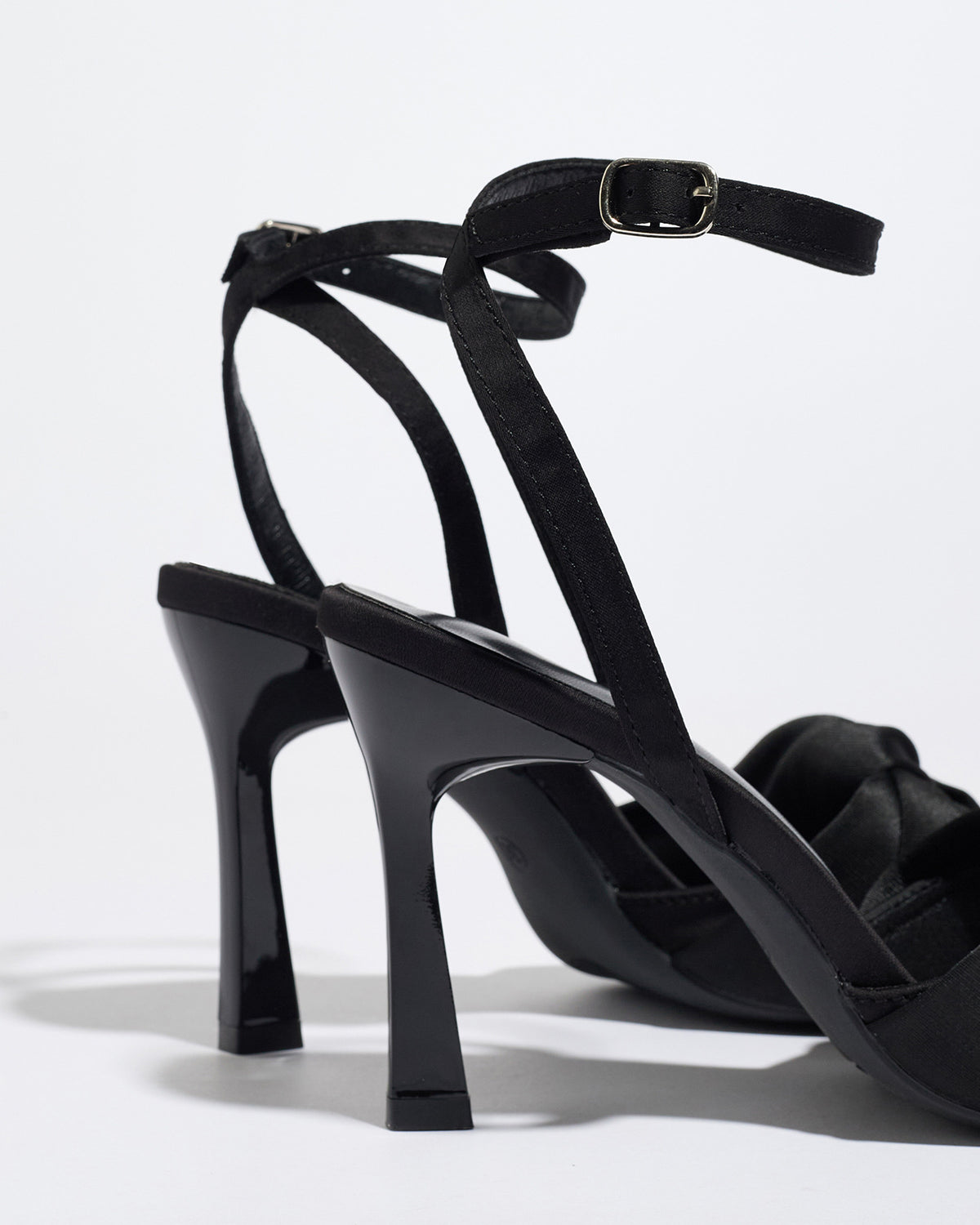 Mescini black knotted satin ankle strap sandals, rear view of the heel and buckle, US women's sizes