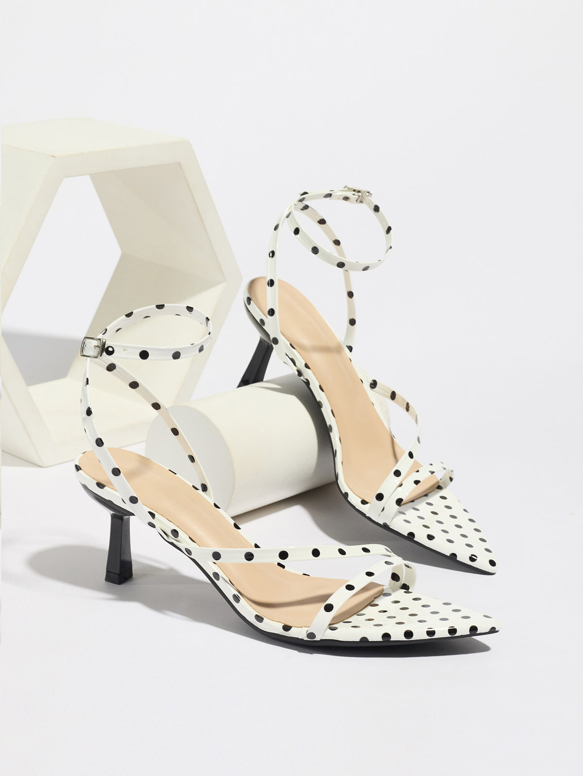 Mescini white polka dot strappy heeled sandals, pair propped on pale blocks, US women's sizes