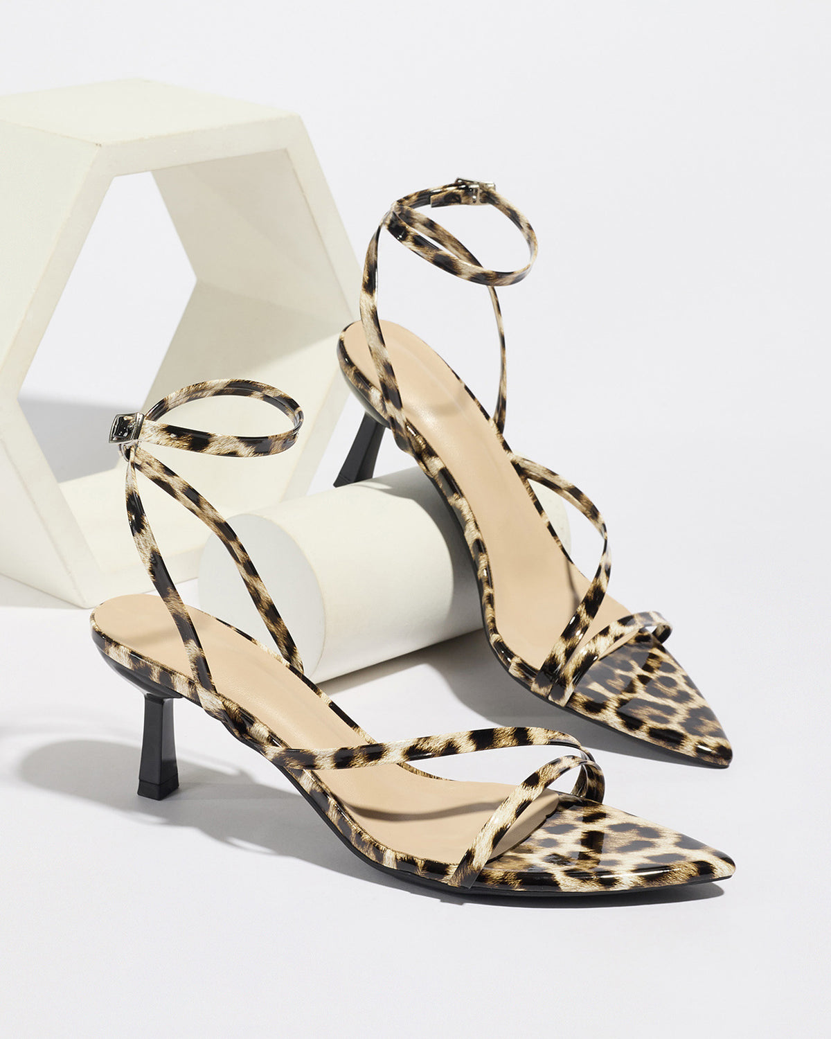 Mescini leopard print strappy heeled sandals, pair propped on white blocks, US women's sizes