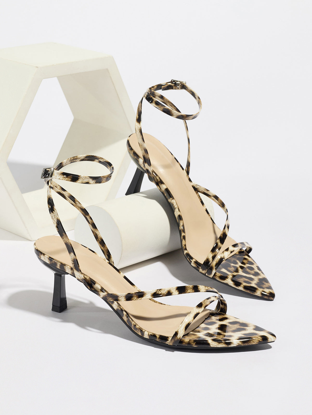 Mescini leopard print strappy heeled sandals, pair propped on white blocks, US women's sizes