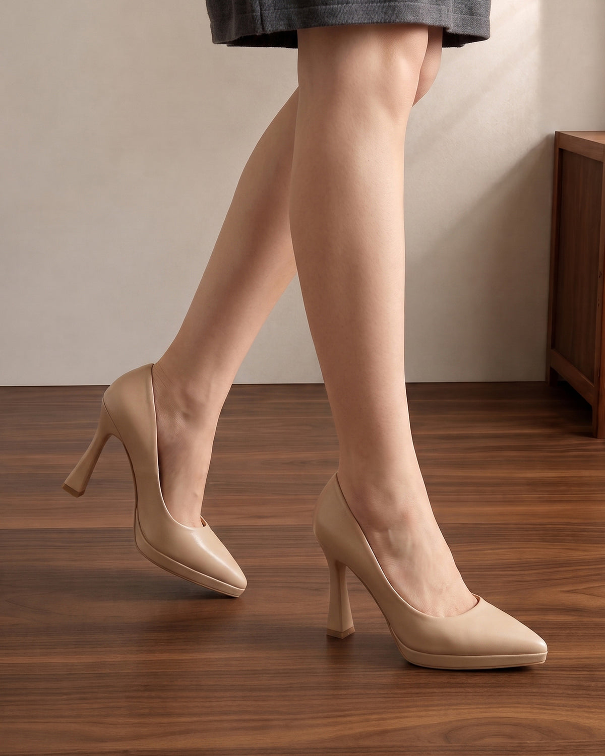Mescini nude sculpted heel pointed toe pumps, worn with one foot lifted in step, US women's sizes