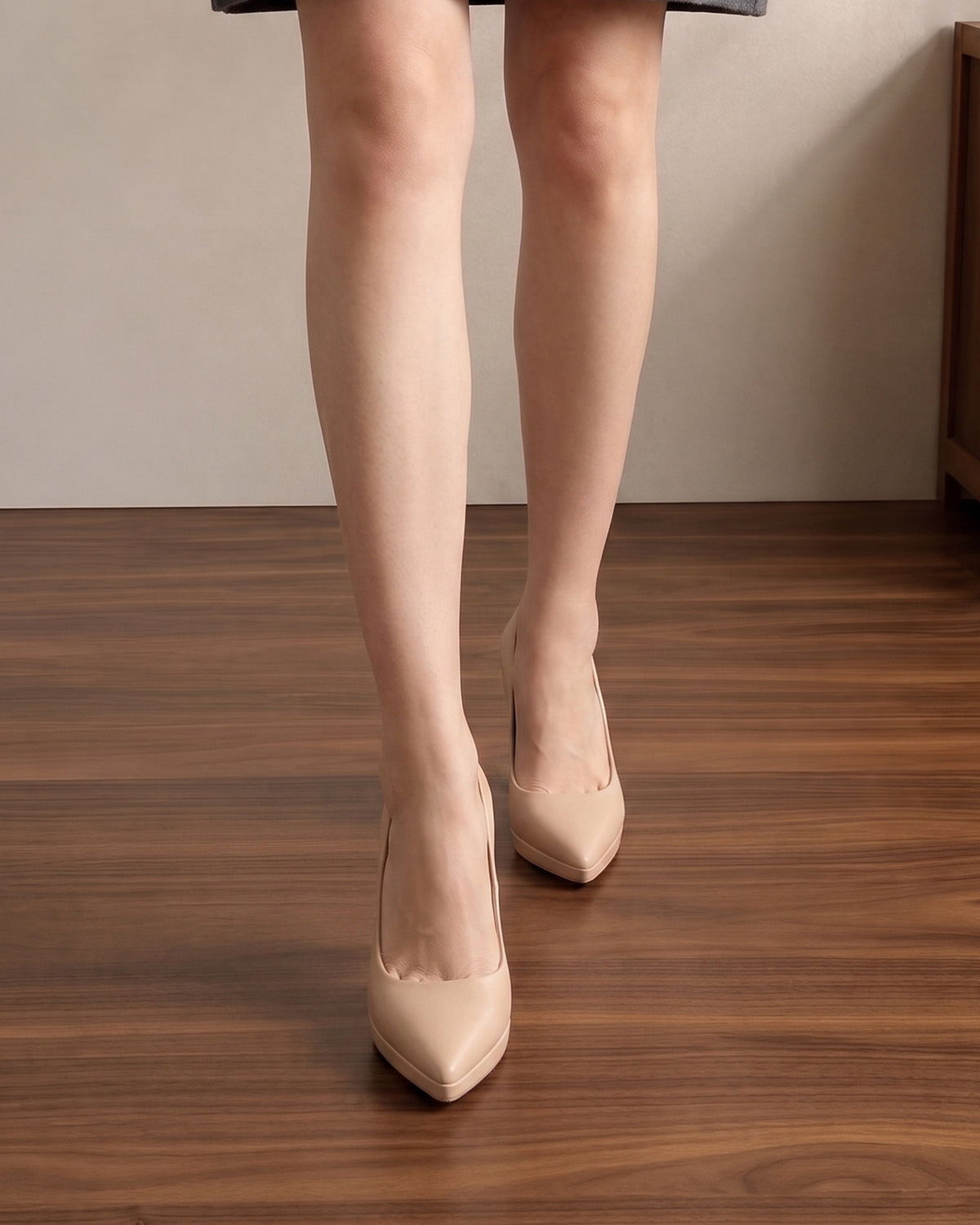Mescini nude sculpted heel pointed toe pumps, worn walking towards the camera, US women's sizes