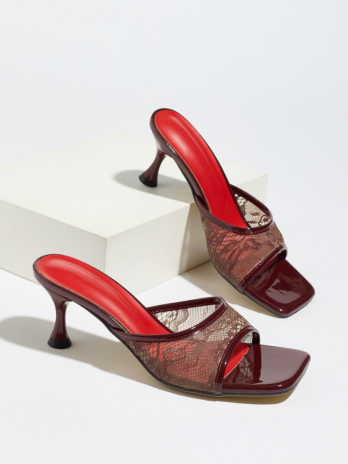 Mescini burgundy lace mesh square toe mule heels, pair set on a white display block, US women's sizes