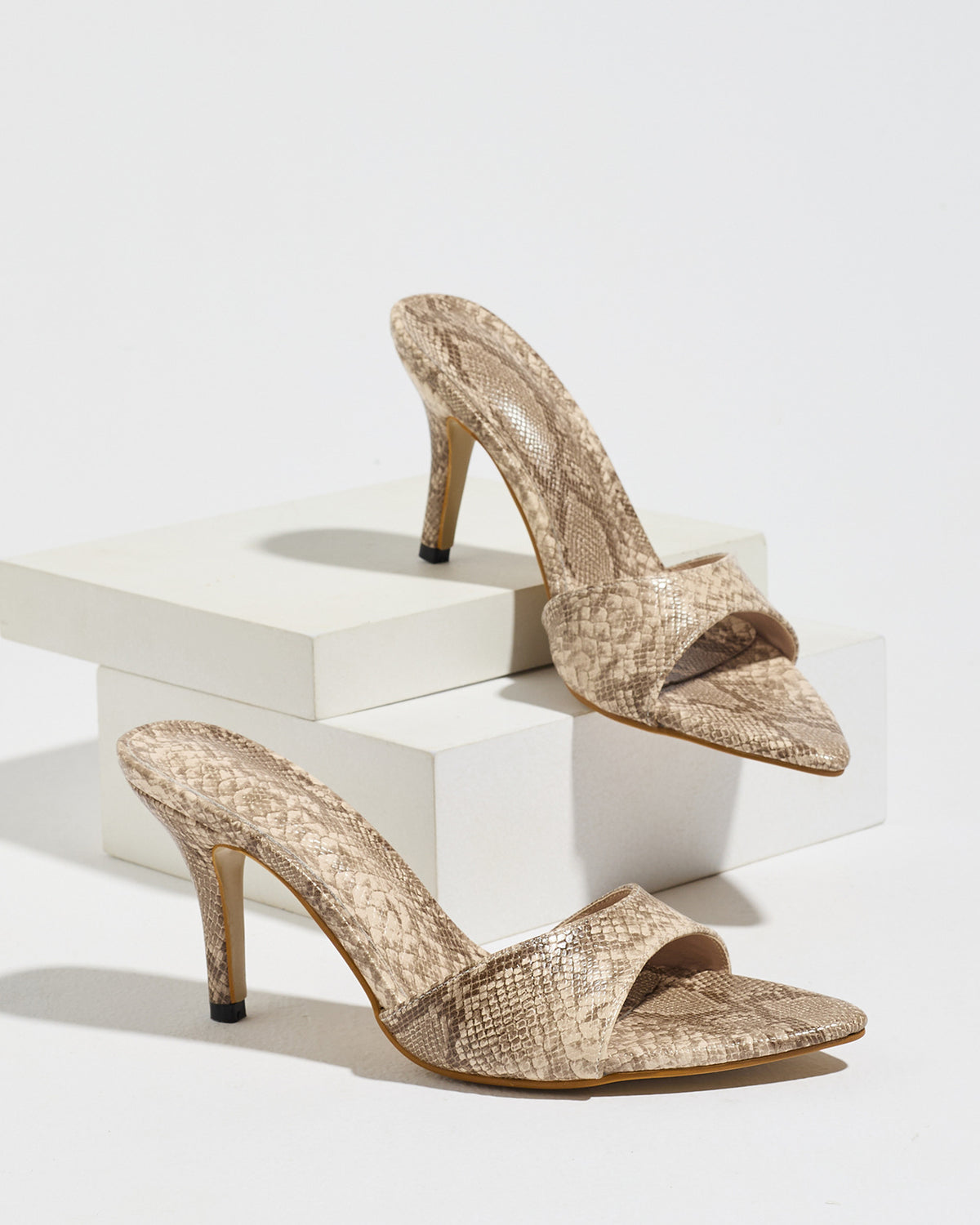 Mescini apricot snake print pointed toe mule heels, the pair on white blocks, US women's sizes