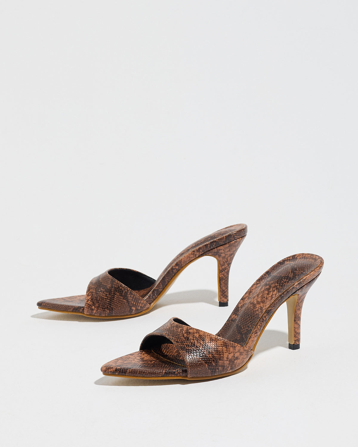 Mescini brown snake print pointed toe mule heels, low angle view of both shoes, US women's sizes