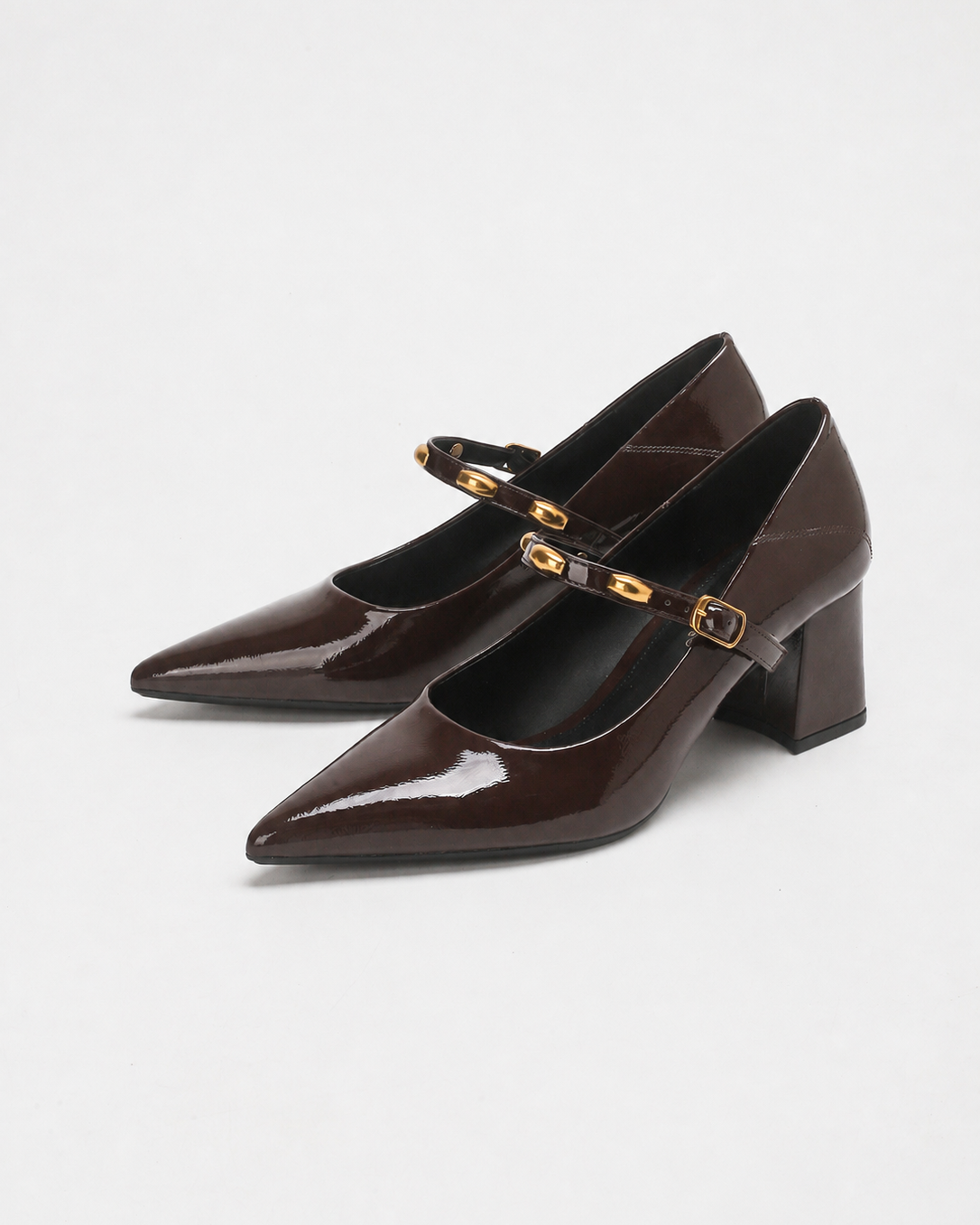 Mescini brown studded strap Mary Jane heels, pair angled on a white background, US women's sizes