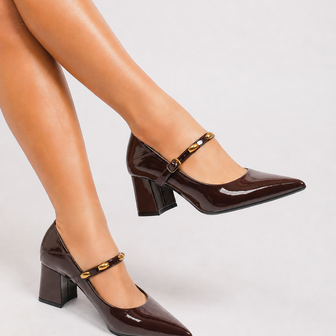 Mescini brown studded strap Mary Jane heels, worn with legs crossed and one foot raised, US women's sizes