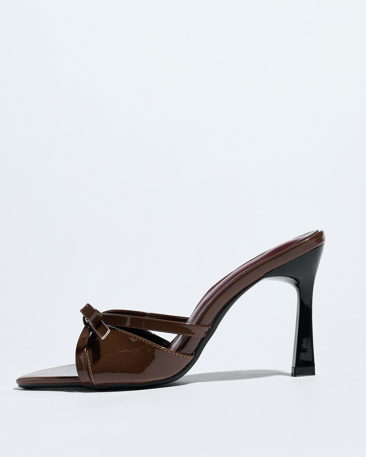 Mescini brown bow pointed toe stiletto mules, one shoe seen from the side, US women's sizes