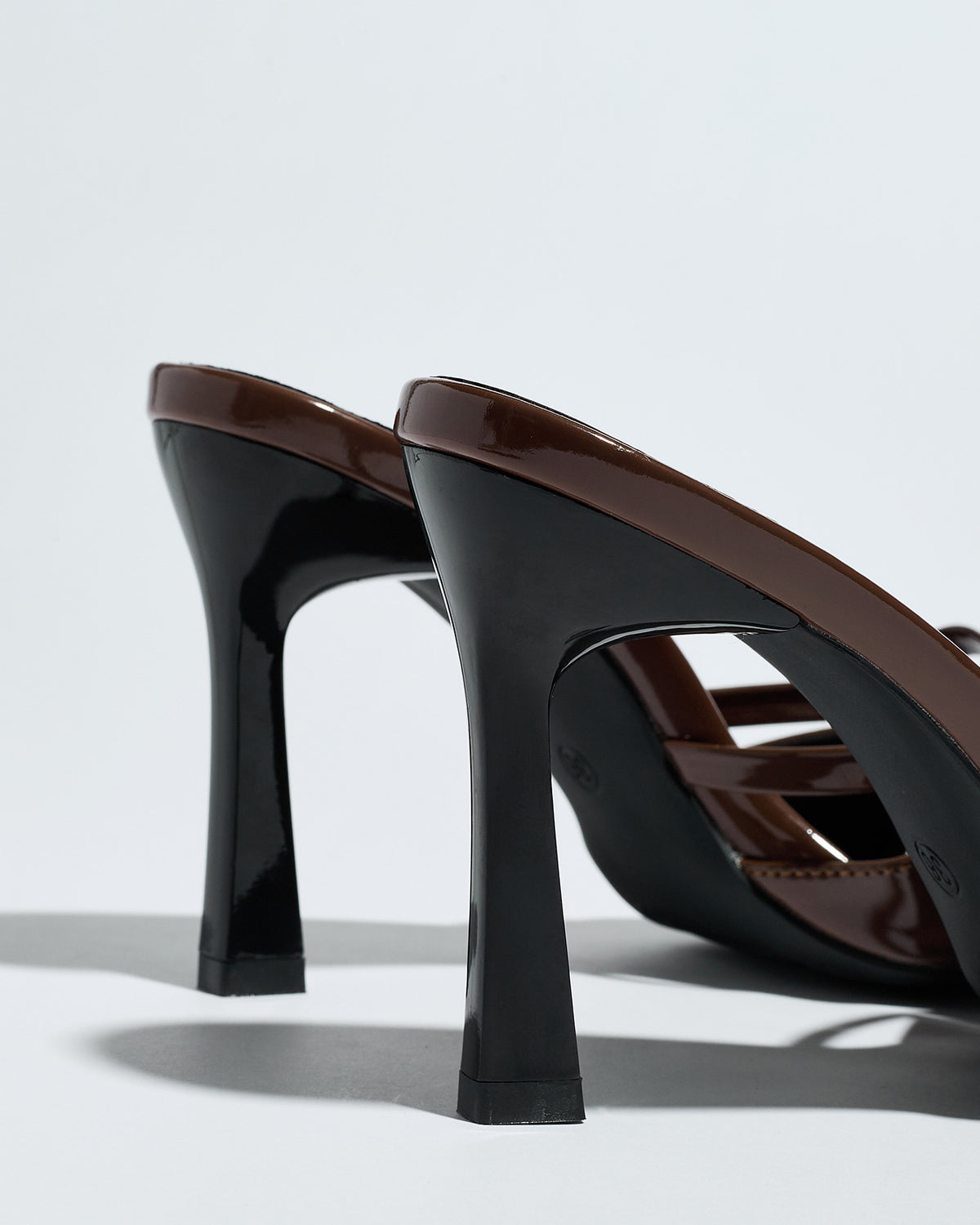 Mescini brown bow pointed toe stiletto mules, rear view of the two heels, US women's sizes