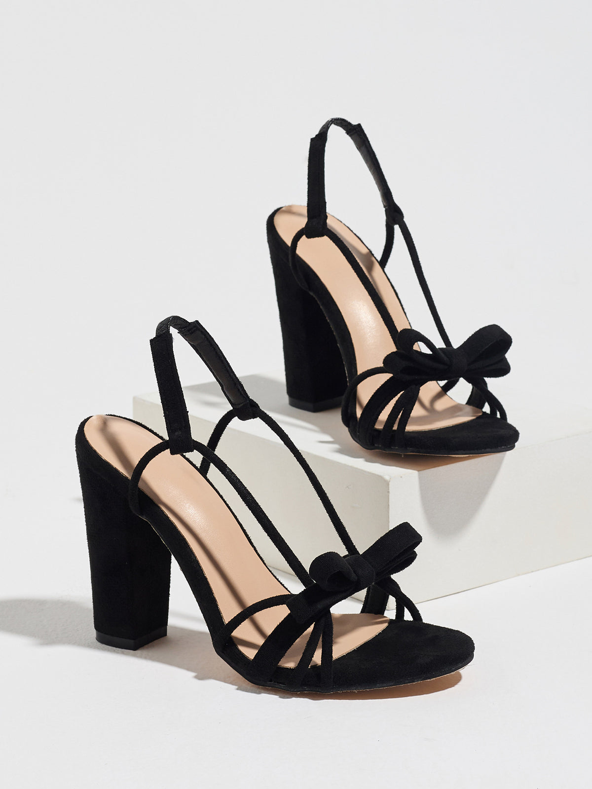 Mescini black knotted bow strappy block heel sandals, angled pair view on grey, US women's sizes