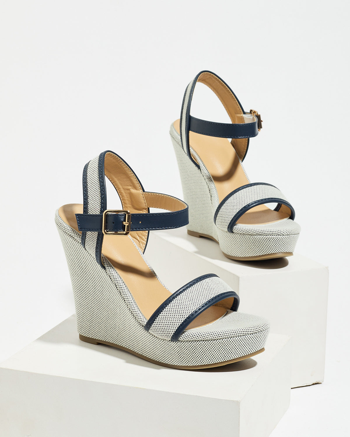 Mescini navy blue canvas platform wedge sandals, one shoe posed on a white riser, US women's sizes