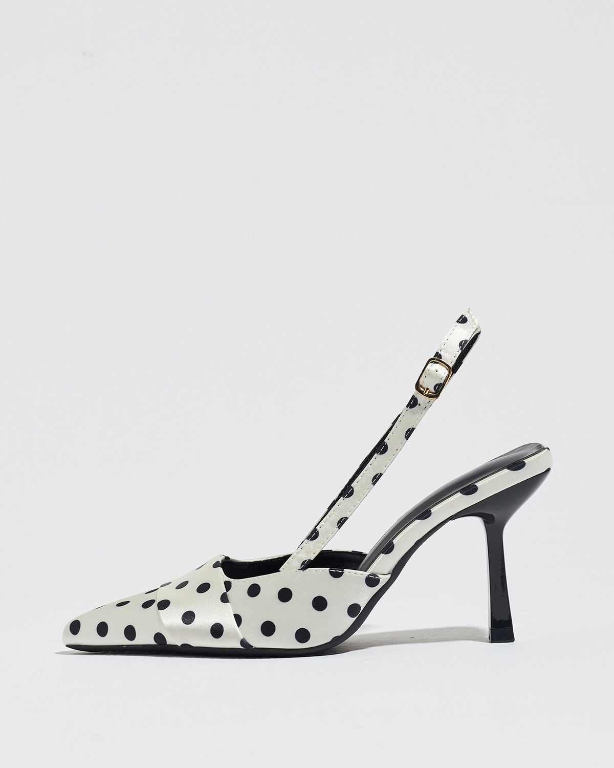 Mescini white polka dot slingback stiletto heels, single shoe seen from the side, US women's sizes