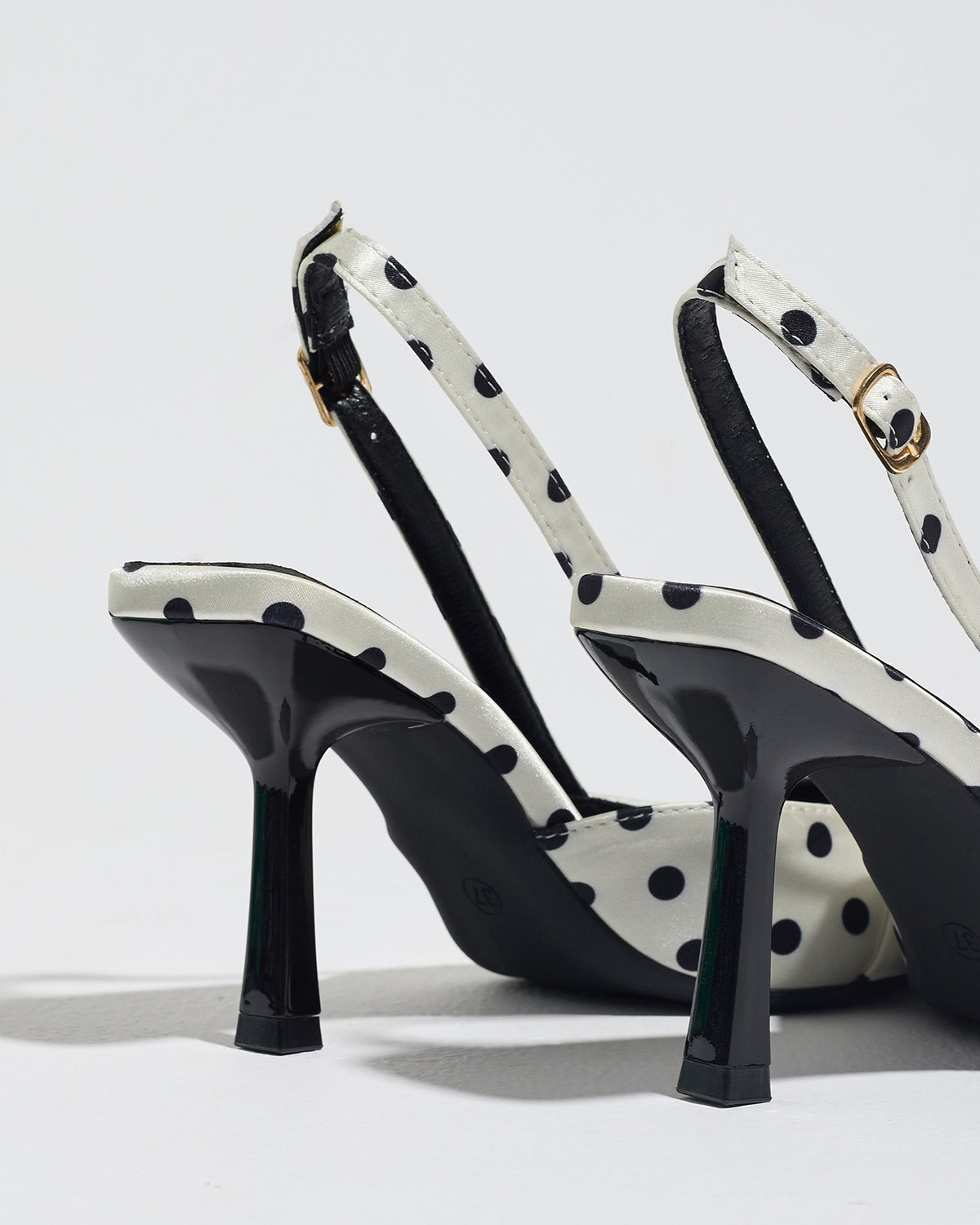 Mescini white polka dot slingback stiletto heels, rear view of the ankle strap and buckle, US women's sizes