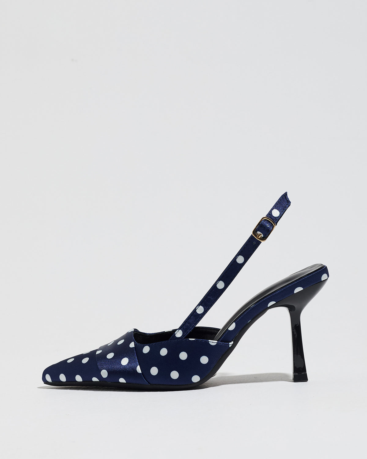Mescini navy polka dot slingback stiletto heels, single shoe photographed from the side, US women's sizes