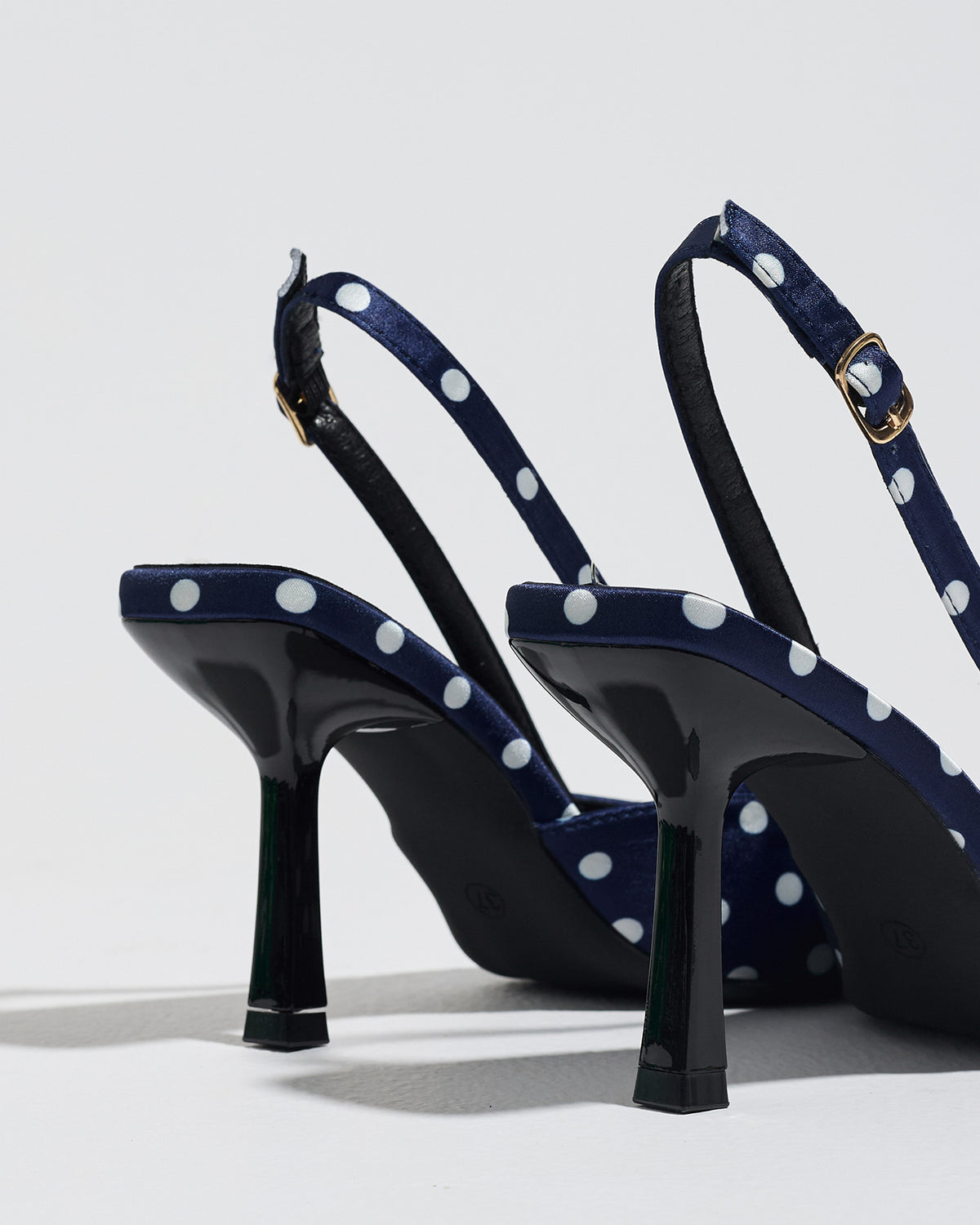 Mescini navy polka dot slingback stiletto heels, rear view showing the buckle strap, US women's sizes