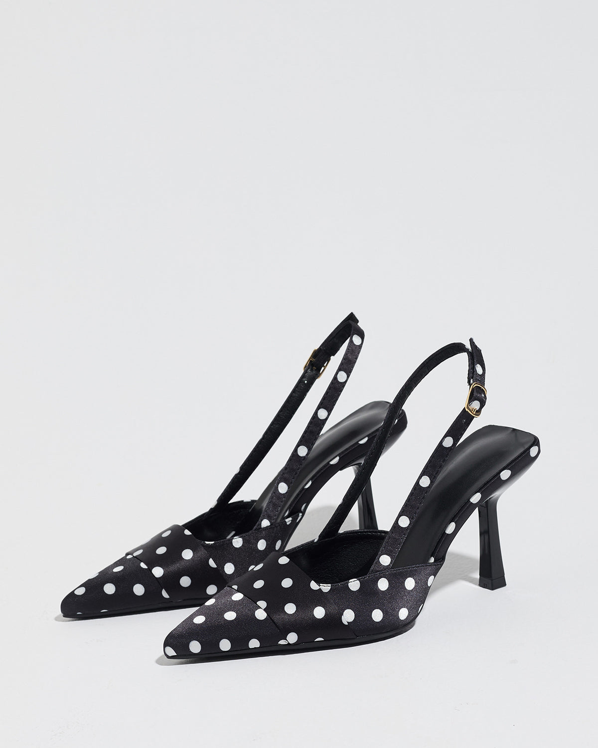 Mescini black polka dot slingback stiletto heels, pair angled with the straps upright, US women's sizes