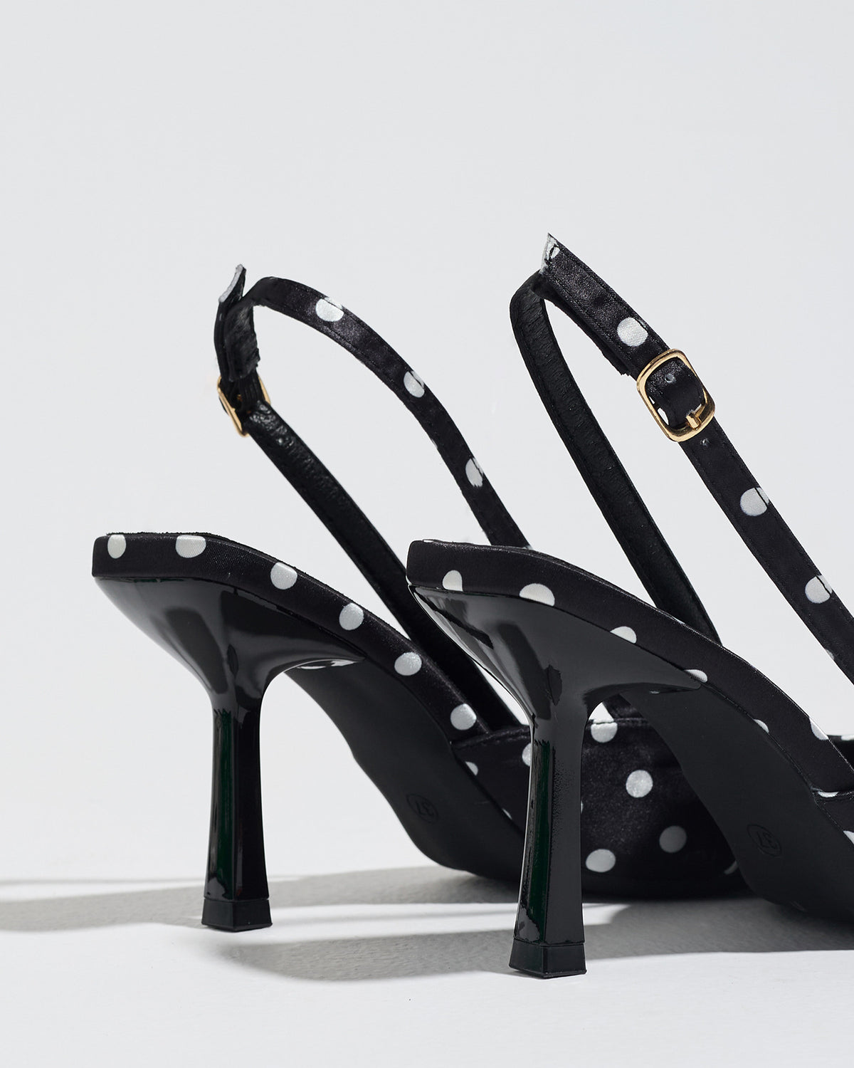 Mescini black polka dot slingback stiletto heels, rear view of the buckle and back strap, US women's sizes