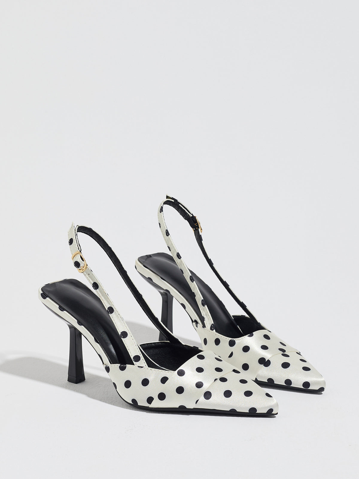 Mescini white polka dot slingback stiletto heels, pair angled on a light grey floor, US women's sizes