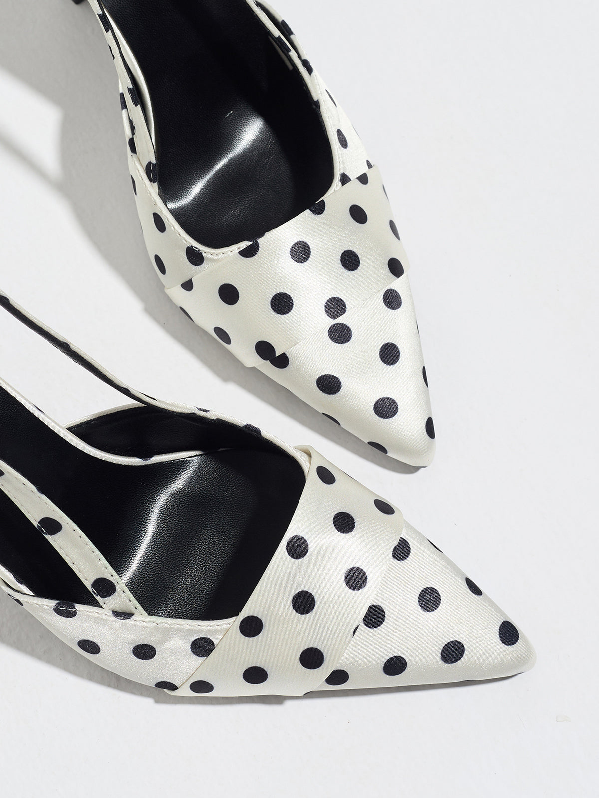 Mescini white polka dot slingback stiletto heels, close up of the tapered pointed toes, US women's sizes