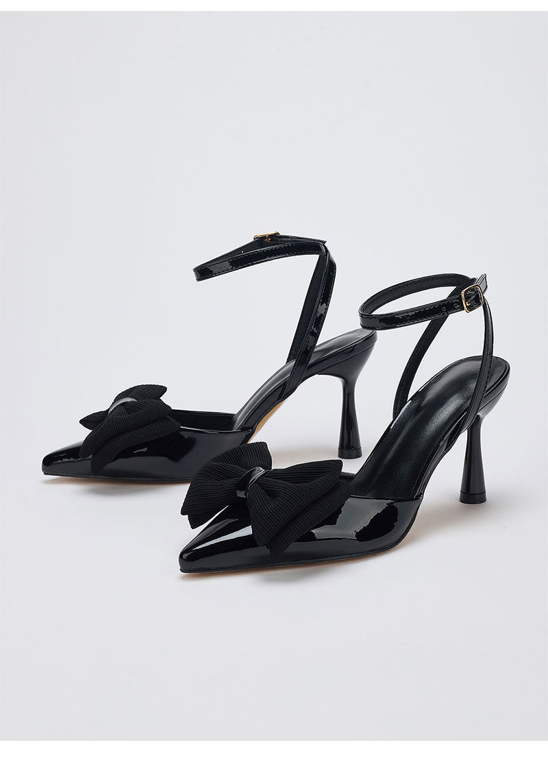 Mescini – Black bow pointed toe ankle strap pumps, angled studio pair, US women's sizes