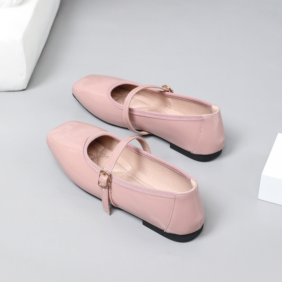 Mescini pink patent square toe mary jane flats, pair angled beside a white block, US women's sizes