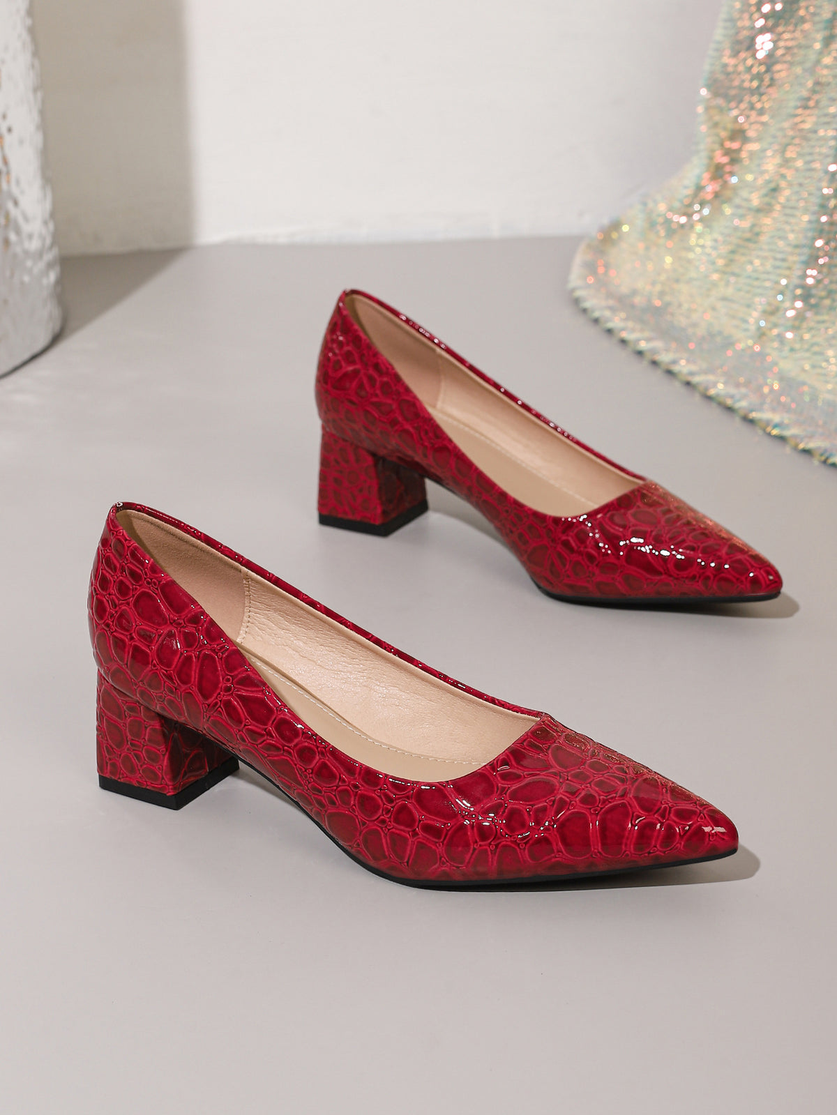 Mescini wine red croc embossed block heel pumps, the pair set on a pale step, US women's sizes