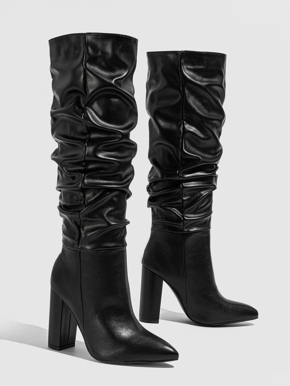 Mescini black slouchy knee high block heel boots, the pair standing on grey ground, US women's sizes