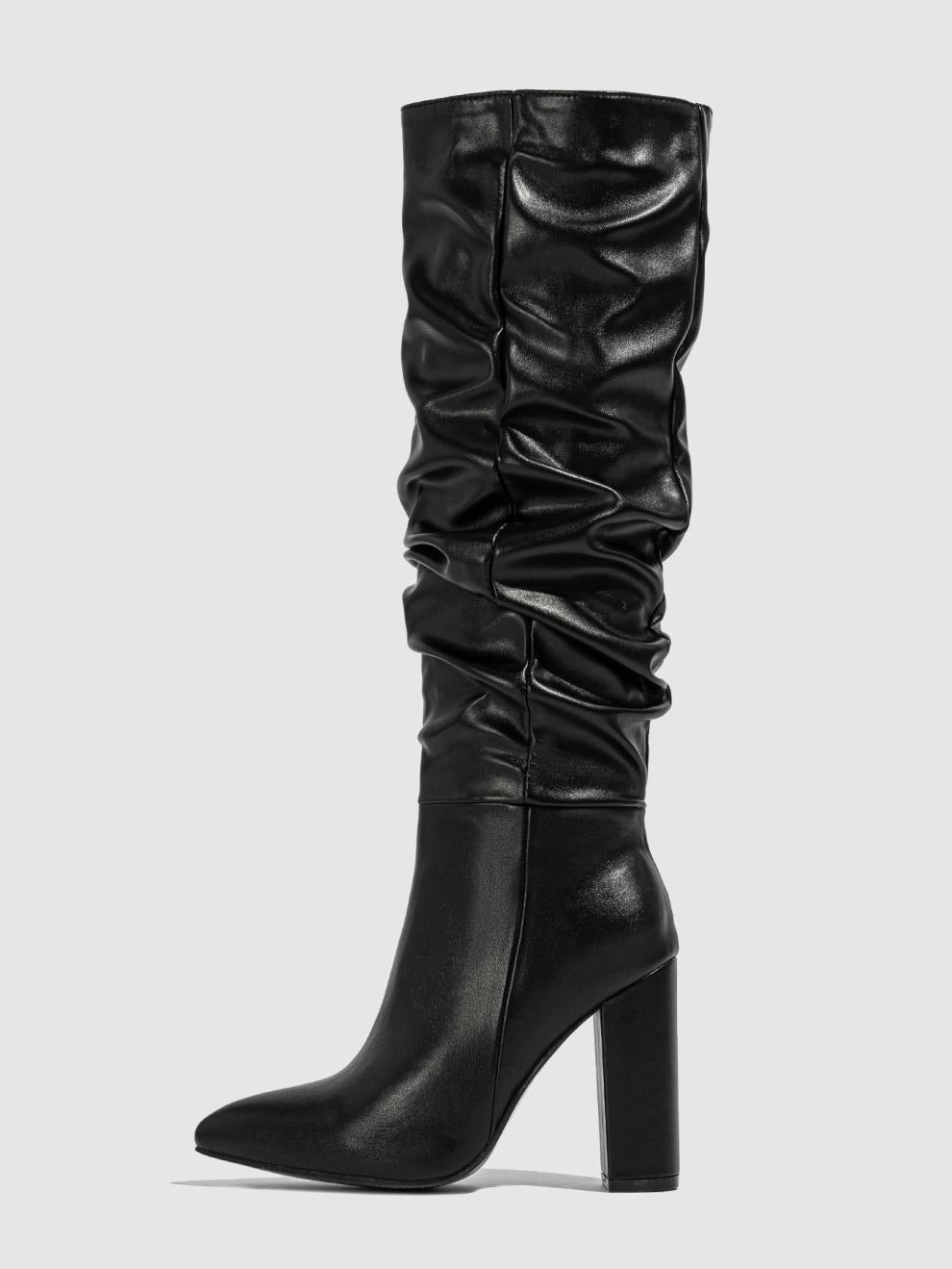 Mescini black slouchy knee high block heel boots, one boot standing on grey ground, US women's sizes