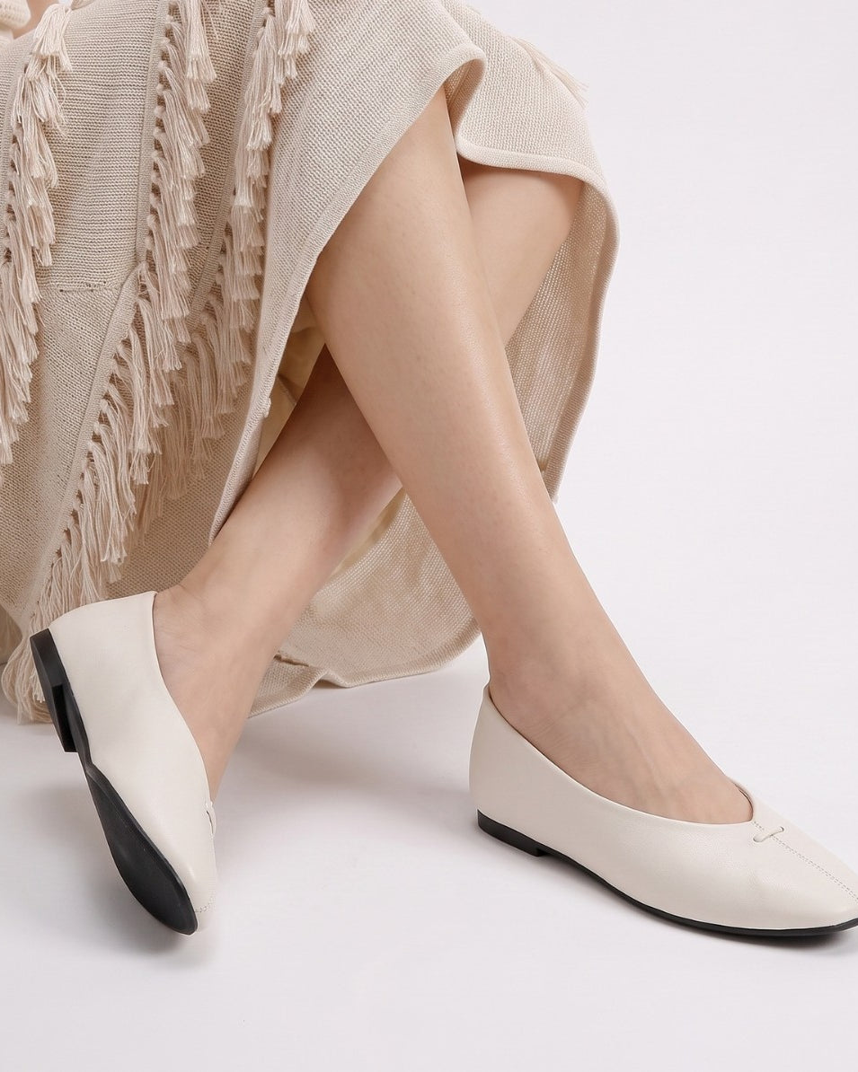 Mescini - off-white ballet flats worn seated, deep V vamp shown, US women's sizes