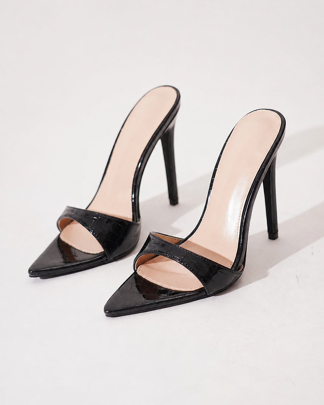 Mescini black croc embossed pointed stiletto mules, the pair angled on a pale grey backdrop, US women's sizes