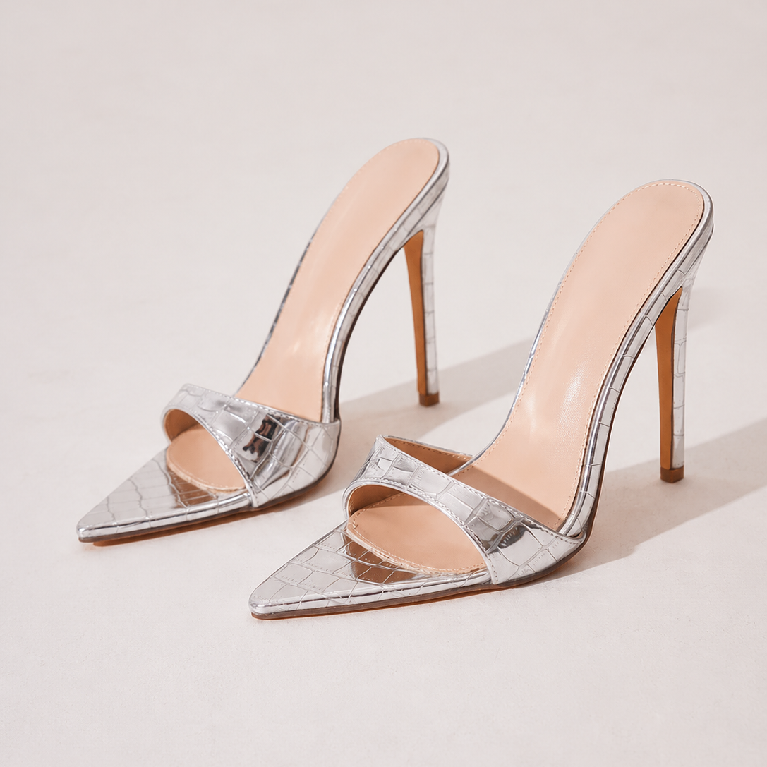 Mescini silver croc embossed pointed stiletto mules, pair placed together in the studio, US women's sizes