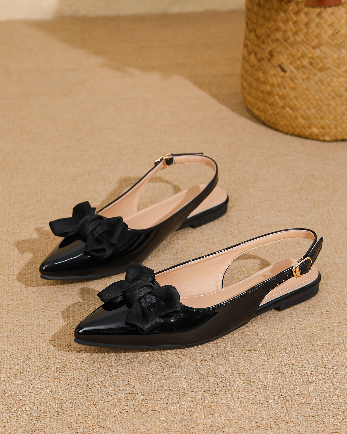 Mescini black bow pointed toe slingback flats, pair resting on a beige woven mat, US women's sizes