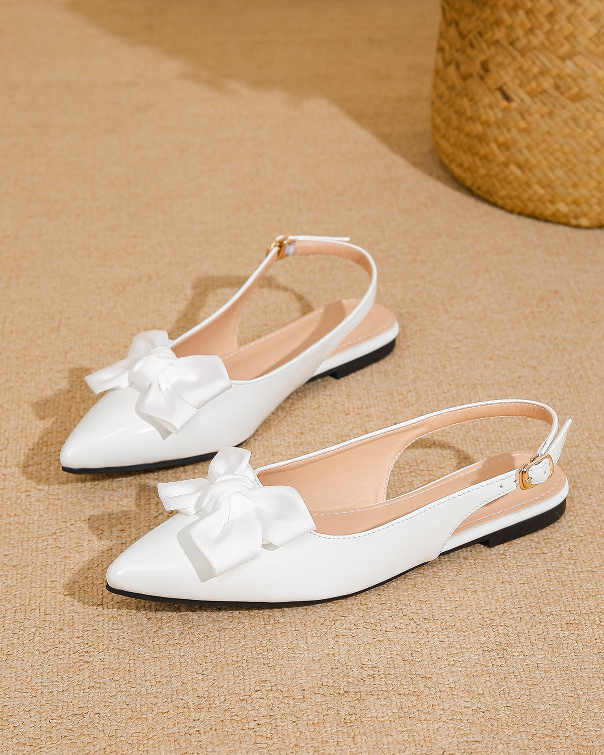 Mescini white bow pointed toe slingback flats, pair set on a woven beige surface, US women's sizes
