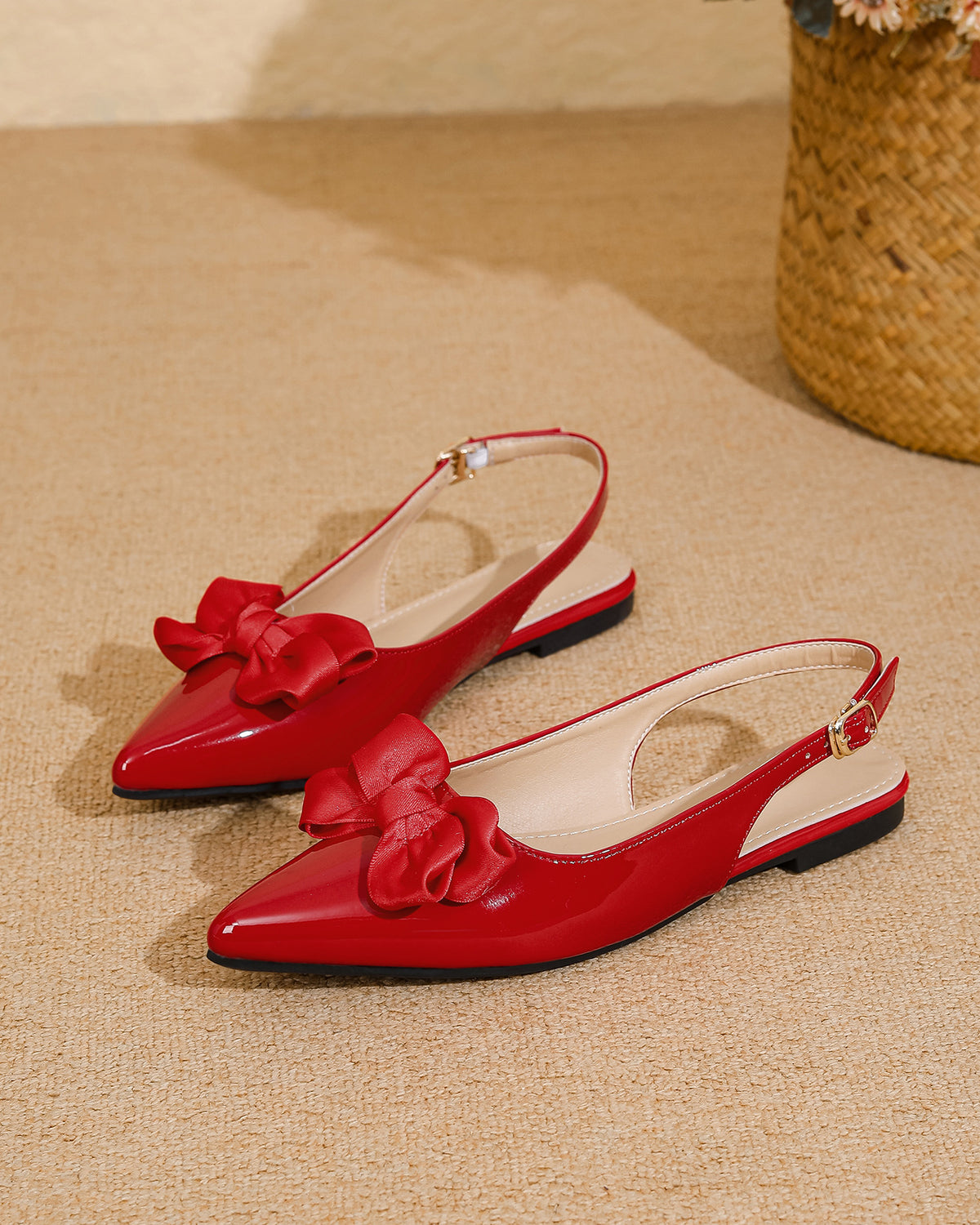 Mescini red bow pointed toe slingback flats, pair placed on a sandy coloured floor, US women's sizes