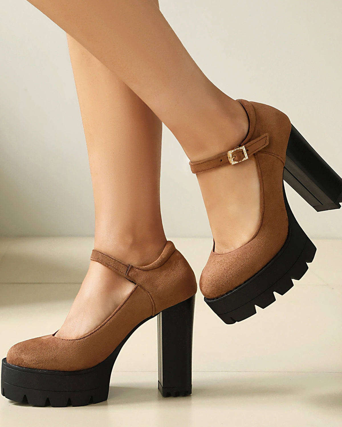 Mescini brown platform Mary Jane block heel pumps worn with one foot lifted, US women's sizes