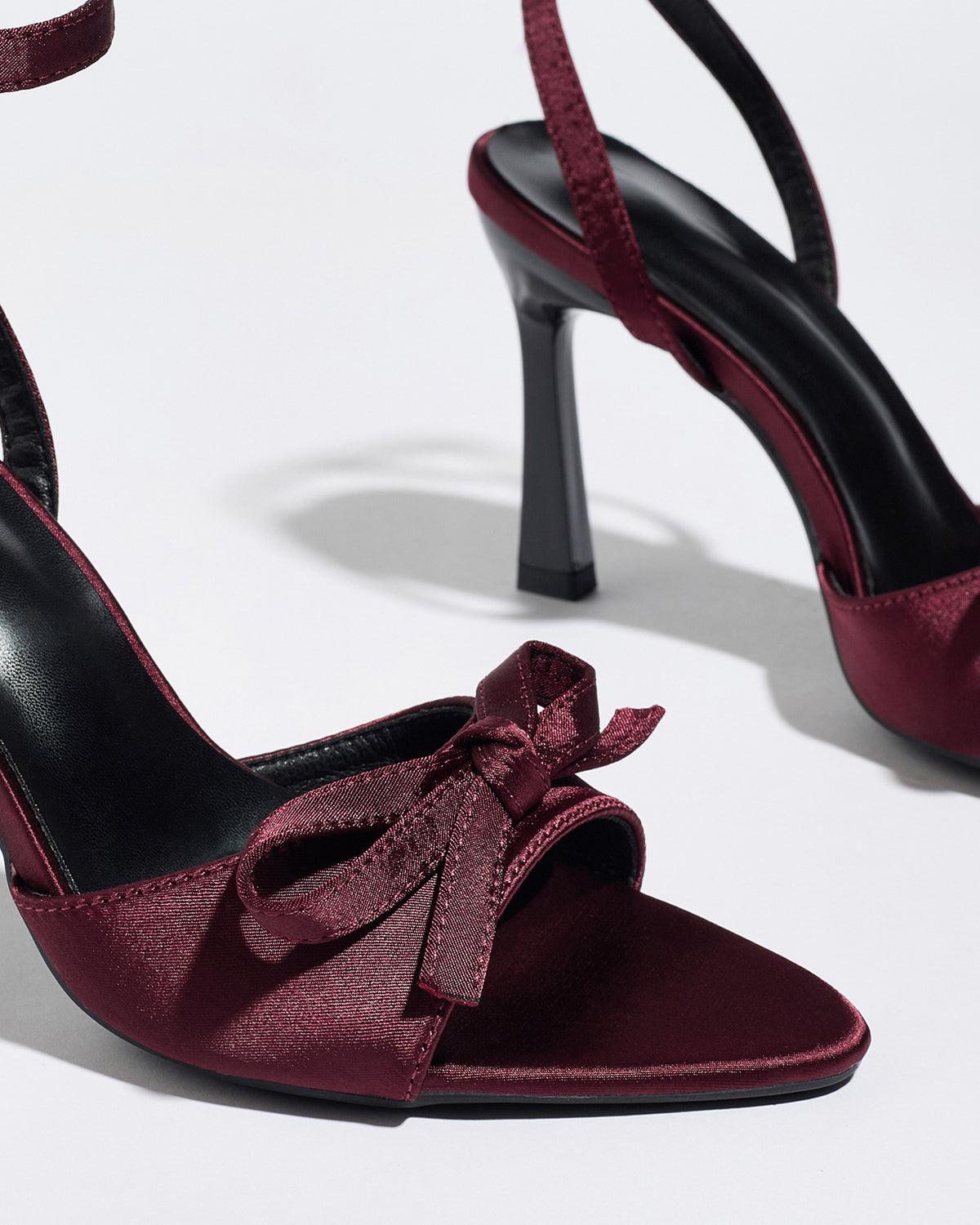 Mescini burgundy satin bow ankle strap sandals, close up of the knot at the pointed toe, US women's sizes