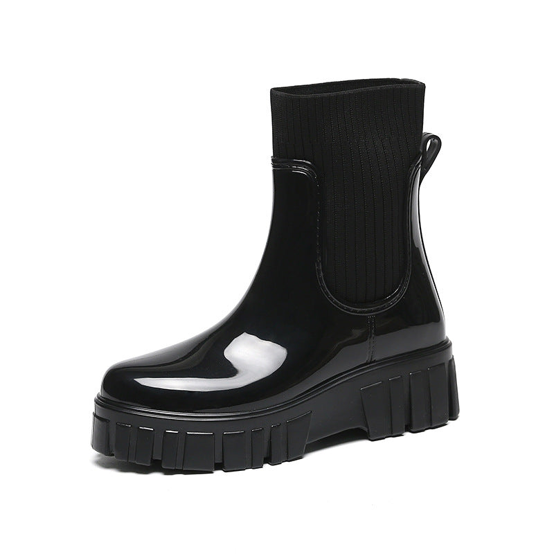 Mescini black glossy platform chelsea rain boots, single shoe on a plain ground, US women's sizes