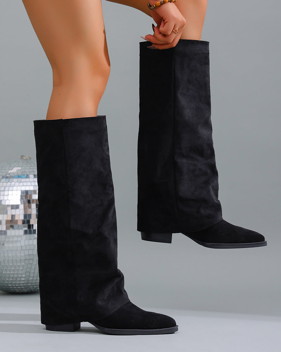 Mescini black fold over knee high boots worn beside a mirror ball, US women's sizes