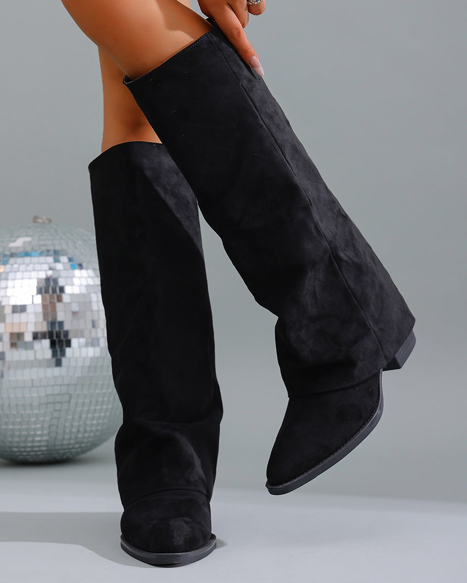 Mescini black fold over knee high boots worn with one leg lifted back, US women's sizes