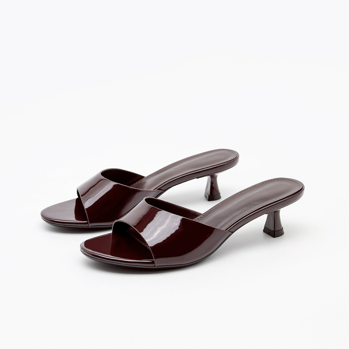 Mescini – Burgundy patent slide mules, studio pair seen from the front, US women's sizes