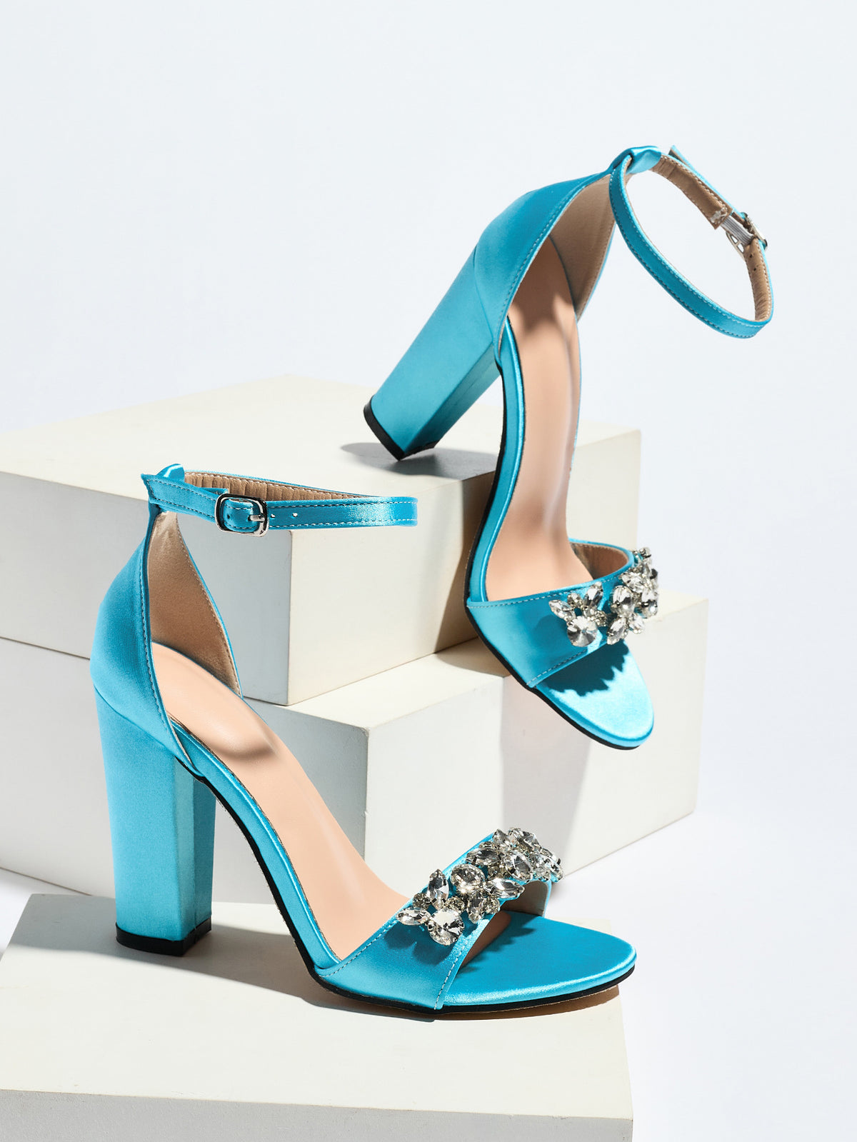 Mescini sky blue crystal strap block heel sandals, pair posed on white blocks, US women's sizes