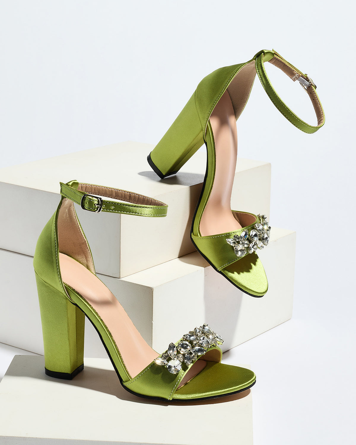 Mescini olive crystal strap block heel sandals, pair arranged on white blocks, US women's sizes